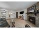 Open-concept living room featuring a stone fireplace and hardwood floors at 8335 Fairmount Dr # 2-105, Denver, CO 80247