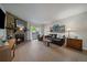 Cozy living room featuring a stone fireplace, hardwood floors and natural lighting at 8335 Fairmount Dr # 2-105, Denver, CO 80247