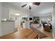 Open-concept living space with fireplace, hardwood flooring, and easy access to kitchen and outdoor area at 8335 Fairmount Dr # 2-105, Denver, CO 80247