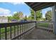 View from a covered patio overlooking parking and a grassy area at 8335 Fairmount Dr # 2-105, Denver, CO 80247