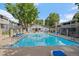 Sparkling community pool surrounded by lounge chairs and well-maintained landscaping at 8335 Fairmount Dr # 2-105, Denver, CO 80247