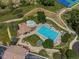 Aerial view of a community pool with a clubhouse, lounge chairs, and landscaping at 7131 S Wenatchee Way # C, Aurora, CO 80016