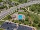 Aerial view of a community pool, playground, parking lot, and surrounding neighborhood at 7131 S Wenatchee Way # C, Aurora, CO 80016