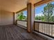 Covered balcony with wood deck and views of surrounding trees at 7131 S Wenatchee Way # C, Aurora, CO 80016