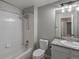 Bright bathroom featuring a shower-tub combo with tiled walls and a granite vanity top at 7131 S Wenatchee Way # C, Aurora, CO 80016