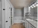 Full bathroom with tub, toilet, and granite topped vanity at 7131 S Wenatchee Way # C, Aurora, CO 80016