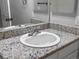 Close-up of bathroom vanity with a granite countertop and a modern faucet at 7131 S Wenatchee Way # C, Aurora, CO 80016