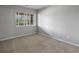 Neutral-toned bedroom with carpeted floors and a sunlit window at 7131 S Wenatchee Way # C, Aurora, CO 80016