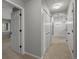 Hallway with bedrooms, closets and neutral carpet at 7131 S Wenatchee Way # C, Aurora, CO 80016
