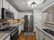 Spacious kitchen with stainless steel appliances, granite counters, and ample storage at 7131 S Wenatchee Way # C, Aurora, CO 80016