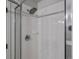 Shower with glass doors, tiled walls, and updated fixtures at 7131 S Wenatchee Way # C, Aurora, CO 80016