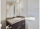 Modern bathroom featuring a sleek vanity, stylish mirror, and a tiled countertop and backsplash at 2514 Sweet Wind Ave, Castle Rock, CO 80109