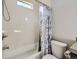 Well-lit bathroom with a shower-tub combo, and tile surround at 2514 Sweet Wind Ave, Castle Rock, CO 80109