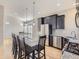 Contemporary kitchen with granite counters, stainless appliances, black cabinets, and a kitchen island with bar stools at 2514 Sweet Wind Ave, Castle Rock, CO 80109