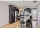Modern kitchen features granite countertops, black cabinets, stainless steel appliances, and island with seating at 2514 Sweet Wind Ave, Castle Rock, CO 80109