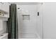 This bathroom has a white tiled shower and tub with a shower curtain at 455 Saddlewood Cir, Highlands Ranch, CO 80126
