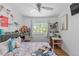 Bedroom featuring wood floors, a large window, and a dedicated workspace with desk at 455 Saddlewood Cir, Highlands Ranch, CO 80126