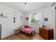Bright bedroom with chandelier, wood floor and natural light from the window at 455 Saddlewood Cir, Highlands Ranch, CO 80126