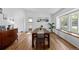 Open dining room featuring wood-look floors, a large window and contemporary decor at 455 Saddlewood Cir, Highlands Ranch, CO 80126
