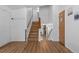 Spacious entryway with wood-look floors and staircase leading to a lower level at 455 Saddlewood Cir, Highlands Ranch, CO 80126