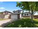 Charming two-story home with attached garage and landscaped yard at 455 Saddlewood Cir, Highlands Ranch, CO 80126