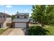 Charming two-story home featuring a well-maintained lawn and a spacious two-car garage at 455 Saddlewood Cir, Highlands Ranch, CO 80126