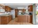 Eat-in kitchen featuring hardwood floors, oak cabinets, and a skylight at 455 Saddlewood Cir, Highlands Ranch, CO 80126