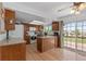 This bright kitchen features wood cabinets, a breakfast bar, and a sliding glass door to the deck at 455 Saddlewood Cir, Highlands Ranch, CO 80126
