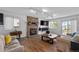 The living room has an updated fireplace, wood floors, neutral furniture, and track lighting at 455 Saddlewood Cir, Highlands Ranch, CO 80126