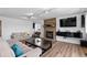 Bright living room boasts a brick fireplace, track lighting, and modern entertainment setup at 455 Saddlewood Cir, Highlands Ranch, CO 80126