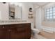 Bright bathroom featuring modern vanity, mirror, shower/tub combo, and tiled walls at 467 Saint Paul St, Denver, CO 80206