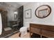 Stylish bathroom with walk-in shower, stone tile, and wood vanity at 467 Saint Paul St, Denver, CO 80206
