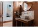 Stylish bathroom with vessel sink, granite countertop, and textured wallpaper at 467 Saint Paul St, Denver, CO 80206