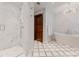 Bright bathroom with marble finishes, walk-in shower, and soaking tub under a modern chandelier at 467 Saint Paul St, Denver, CO 80206