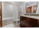 Bright bathroom with white tile, a wooden door, and a vanity with granite countertops at 467 Saint Paul St, Denver, CO 80206