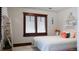Bedroom featuring natural light from window with wooden shutters and artistic decor at 467 Saint Paul St, Denver, CO 80206