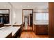 Walk-in closet with hardwood floors, custom storage, and an expansive framed mirror at 467 Saint Paul St, Denver, CO 80206