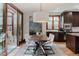 Dining area open to the kitchen with wood-look floors and plenty of room to entertain at 467 Saint Paul St, Denver, CO 80206