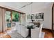 Bright dining room with a glass table, modern lighting, and access to a lush outdoor space at 467 Saint Paul St, Denver, CO 80206