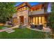 Beautiful stone home featuring an outdoor seating area and manicured lawn at 467 Saint Paul St, Denver, CO 80206