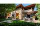 Beautiful stone home featuring an outdoor seating area and manicured lawn at 467 Saint Paul St, Denver, CO 80206