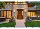 Inviting front entrance with stone accents, manicured lawn, and cozy outdoor seating at 467 Saint Paul St, Denver, CO 80206