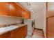 Laundry room featuring ample storage, a utility sink, granite countertops, and a washer/dryer at 467 Saint Paul St, Denver, CO 80206