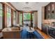 Cozy living room features wood trim, large windows, stylish lighting, and access to an outdoor patio at 467 Saint Paul St, Denver, CO 80206