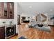 Spacious open-concept living room with wood floors and a stylish bar area, perfect for entertaining at 467 Saint Paul St, Denver, CO 80206