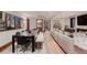 Open-concept living area with dining space, fireplace, and access to bathroom at 467 Saint Paul St, Denver, CO 80206