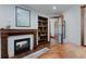 Inviting living room featuring a fireplace, custom wood built-ins, and hardwood flooring at 467 Saint Paul St, Denver, CO 80206