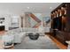 Comfortable living area with a stone accent wall, modern staircase, and built-in display shelving at 467 Saint Paul St, Denver, CO 80206