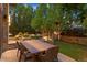 Outdoor dining area with a large table and seating surrounded by lush landscaping at 467 Saint Paul St, Denver, CO 80206