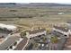 An aerial view of several homes surrounded by green fields and mountains in the distance at 4226 S Eldridge St # 207, Morrison, CO 80465